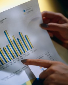 Businesswoman Holding Bar Graph